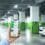 A person holding a cell phone in a parking garage